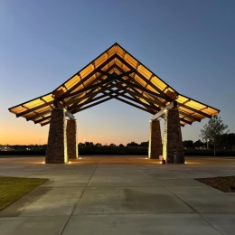 a gazebo with a sunset in the background
