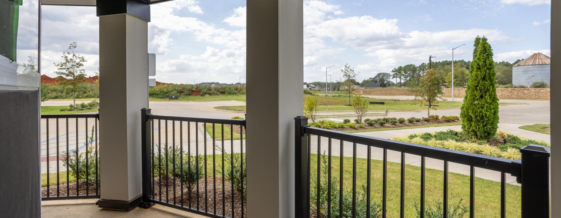 a view of a landscape and trees from a fenced in patio