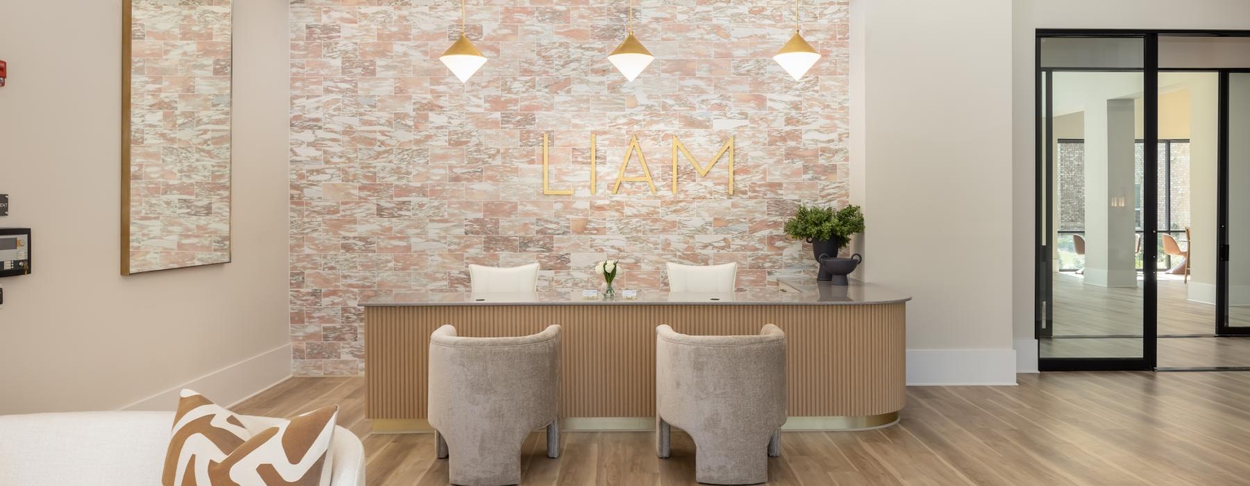 a lobby with a desk and chairs